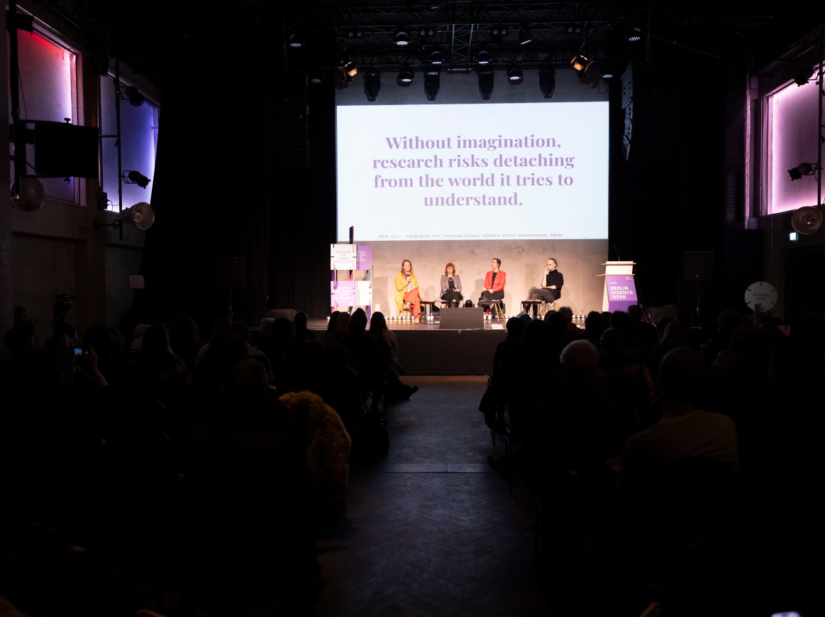A group of people sits on a panel 