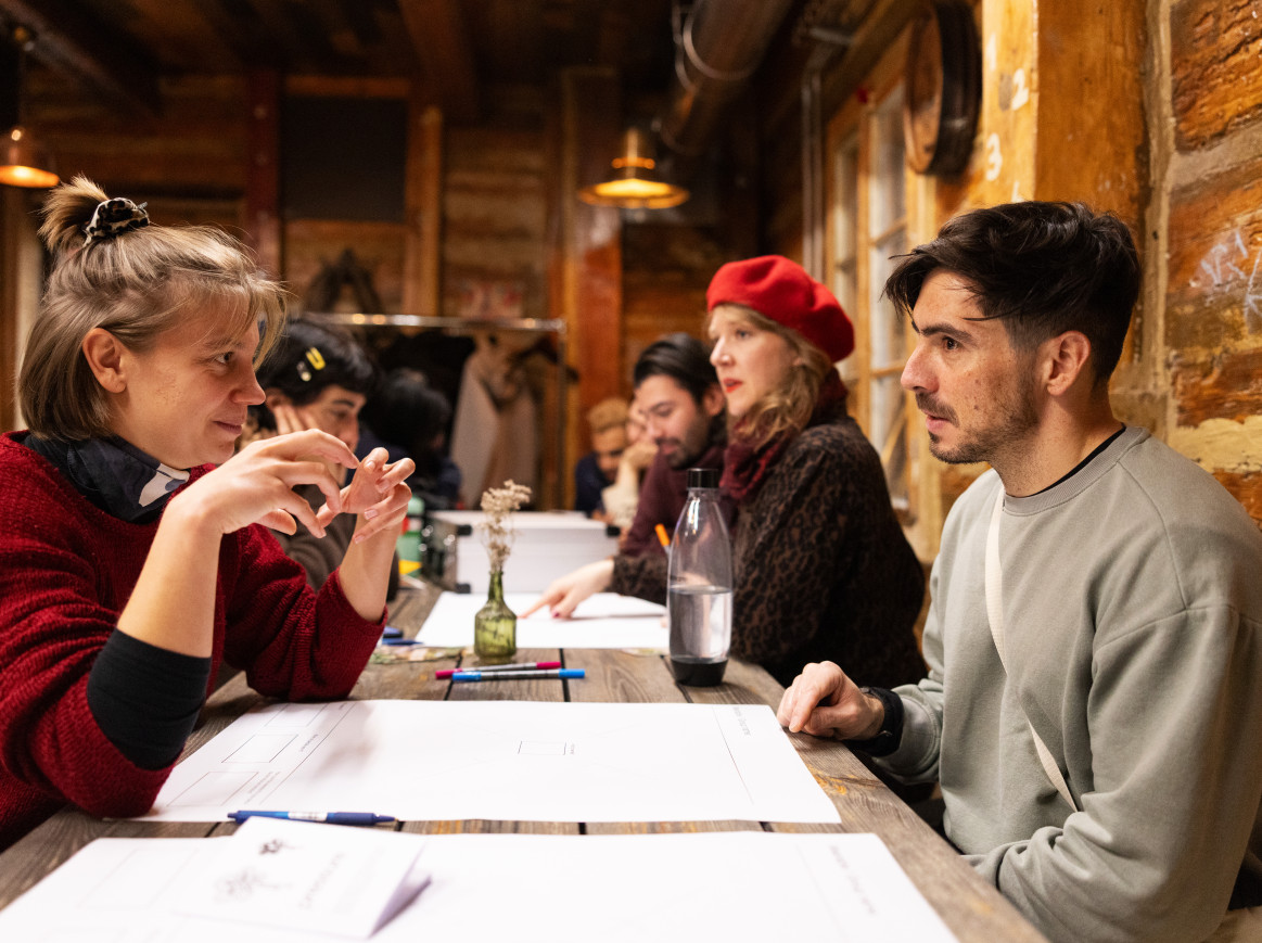People in a workshop looking at one another