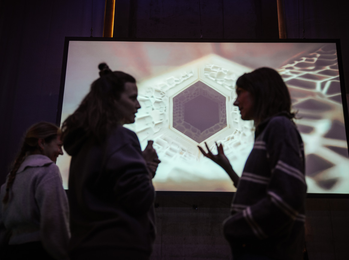 People standing in front of a screen