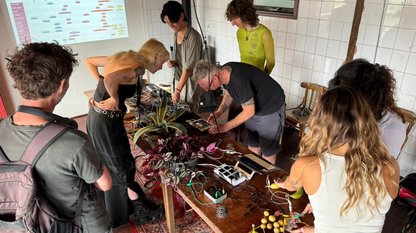 People around a table making sounds with plants and heartbeats