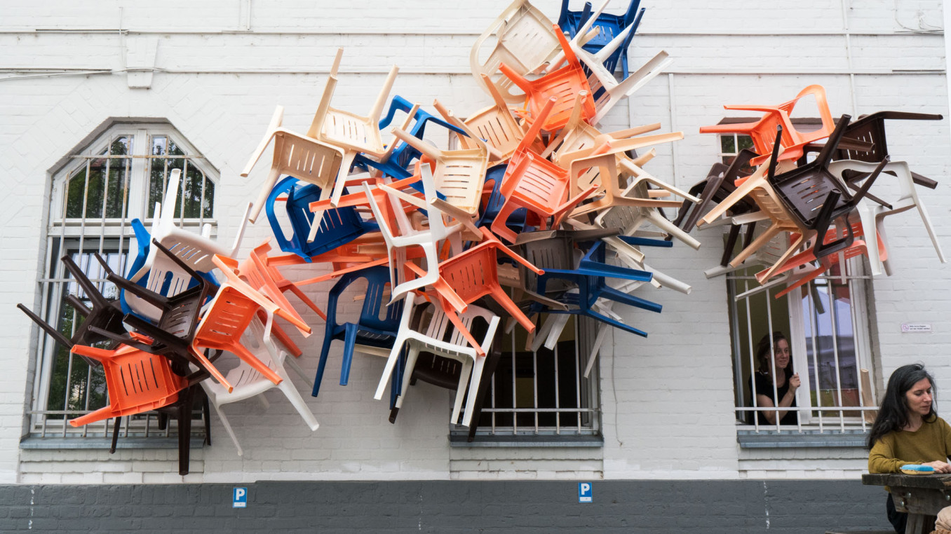 Chairs coming out of windows.