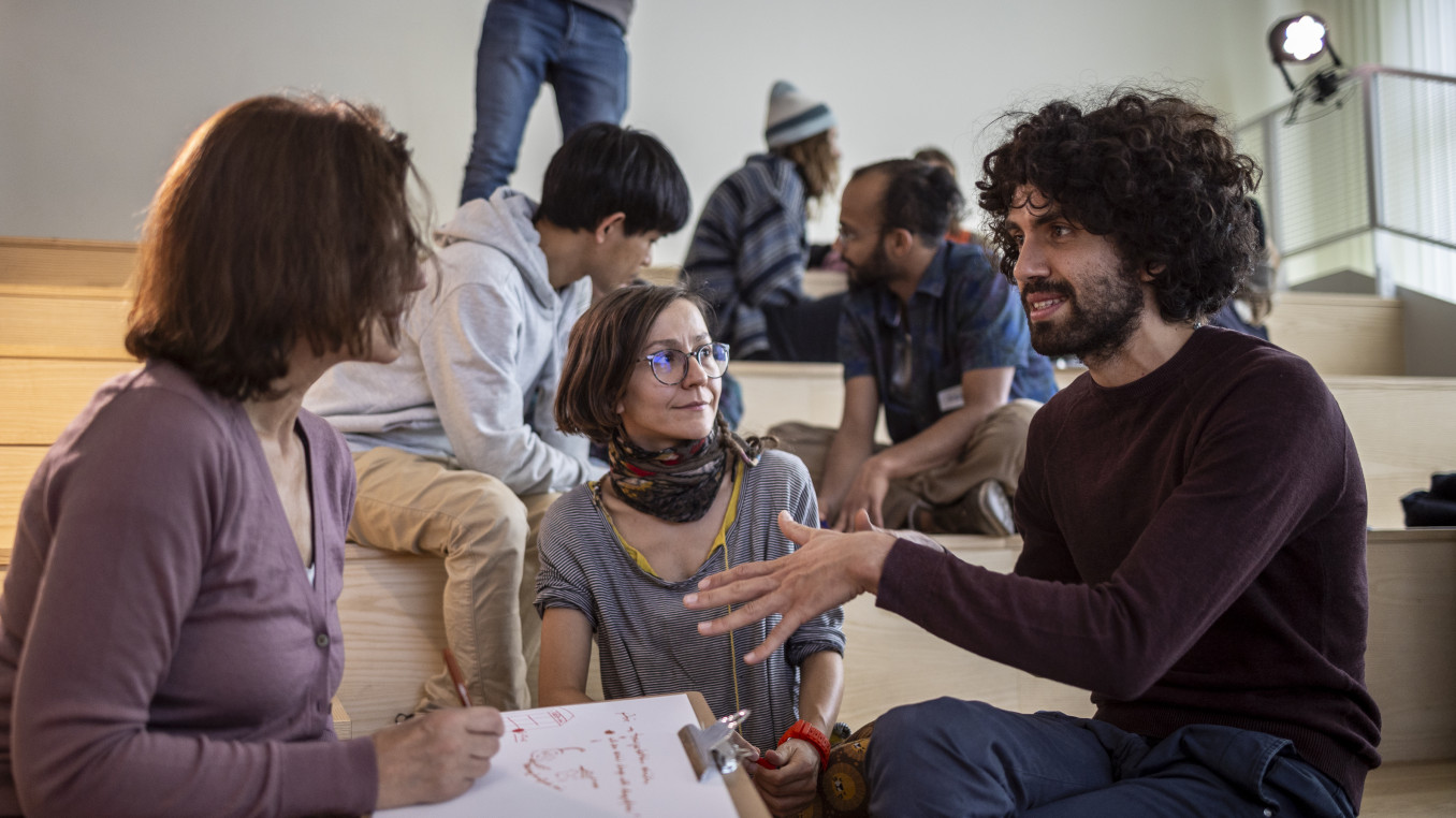 A group sits together brainstorming.