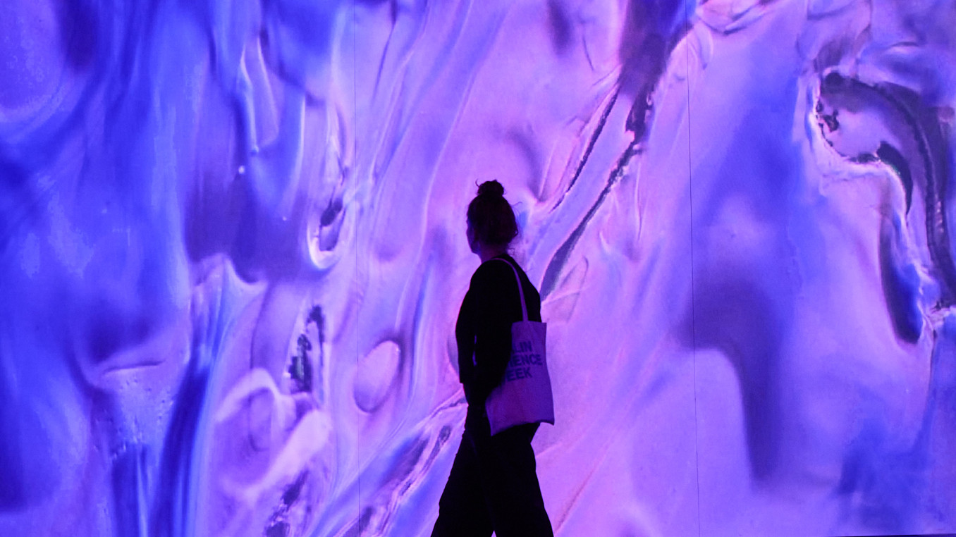 A person walking in front of an exhibition