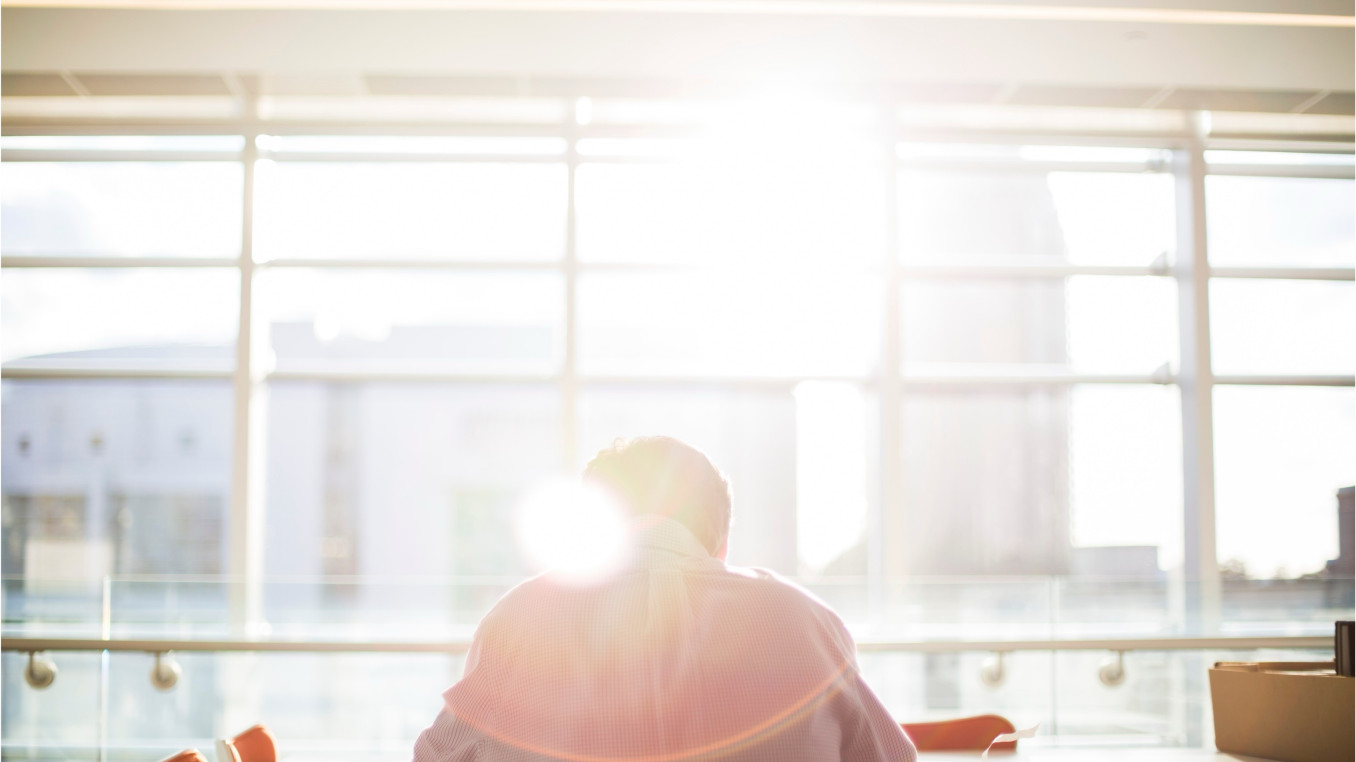 Sunlight through the windows, a man sitting there