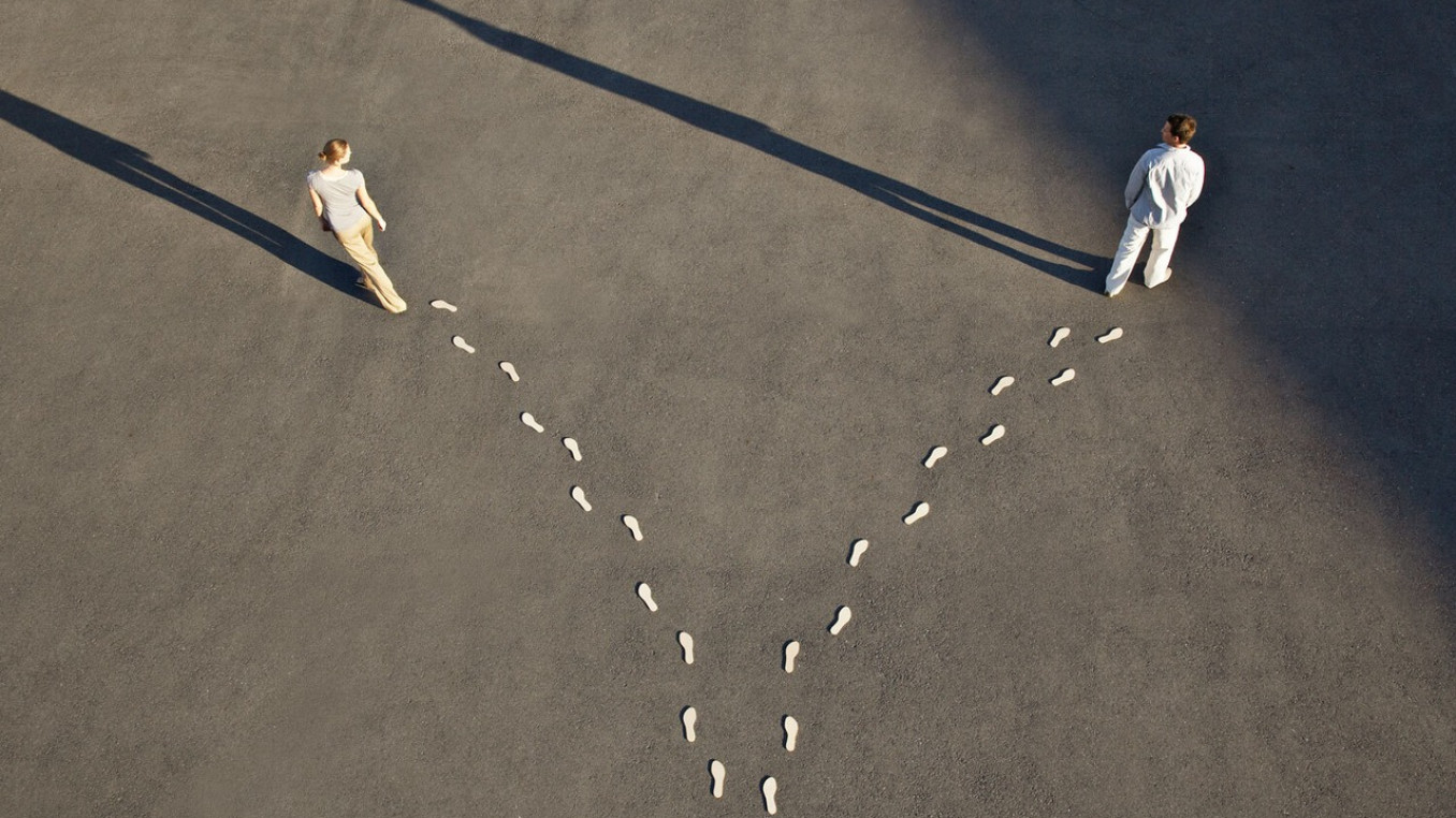 Two people walking in different directions.