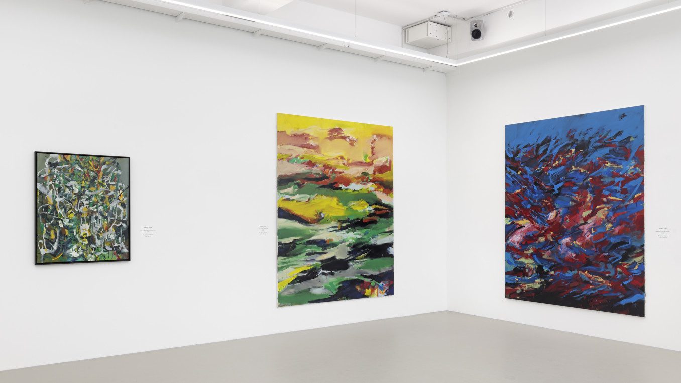Colourful abstract paintings in gallery.